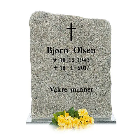 Gravstein i lys granitt med teksten «Bjørn Olsen» og «Vakre minner», pyntet med gule blomster.